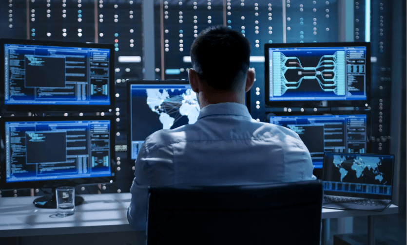 person infront of five screens