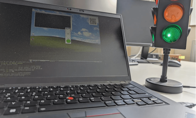 Laptop next to mini traffic light